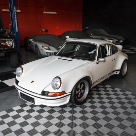 A classic Porsche parked on RaceDeck garage flooring