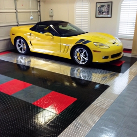 A yellow Corvette in a garage with RaceDeck Pro accents