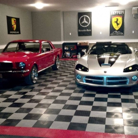 Home garage with gray and black checkered RaceDeck Diamond garage flooring with a red border