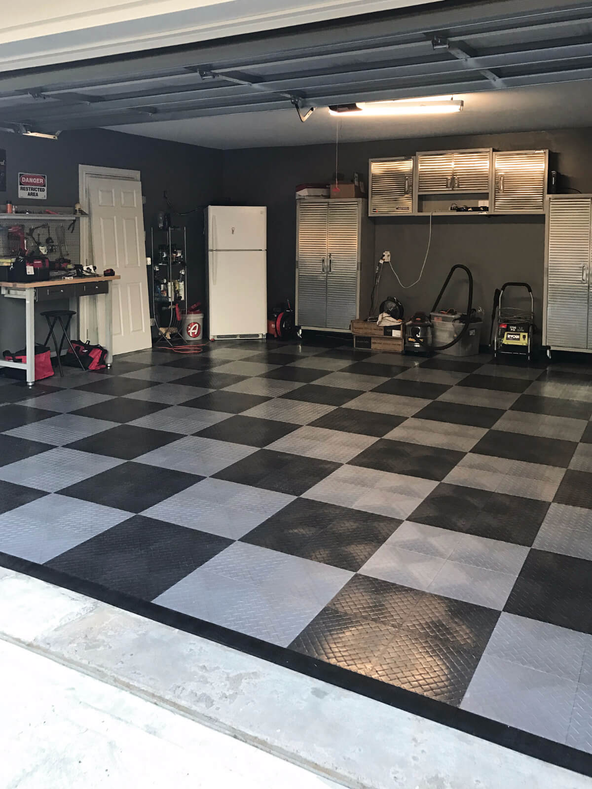 RaceDeck Diamond in graphite and alloy complement the silver cabinets in this garage.