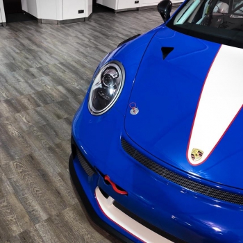 A Porsche parked on Smoked Oak at a SEMA display