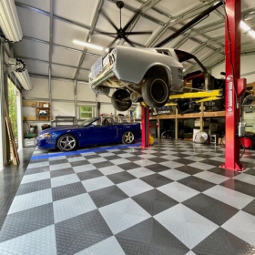 XL flooring in graphite and alloy, garage with lift and multiple cars