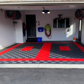 Clean 2-car garage with Free-Flow graphite and red flooring