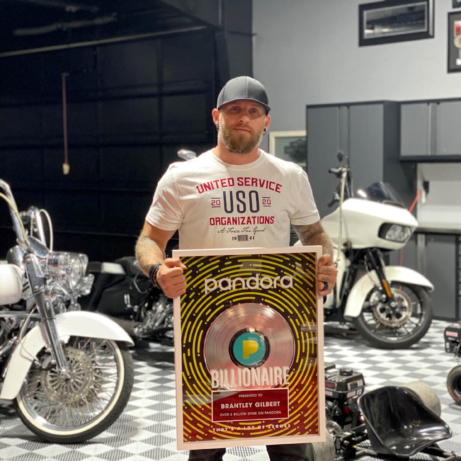 Brantley Gilbert shows his Pandora Billionaire award among his motorcycle collection in his RaceDeck Free-Flow garage