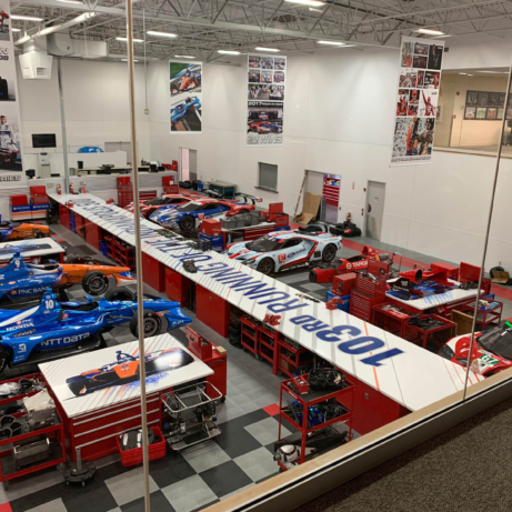 Racecars in a large commercial garage with RaceDeck Diamond flooring