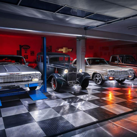 Multi-car garage with lit cars on RaceDeck Diamond flooring