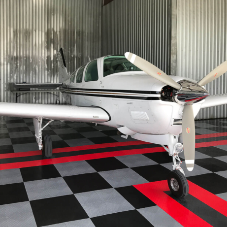 Airplane hangar with RaceDeck Diamond, custom stripes for perfect alignment.