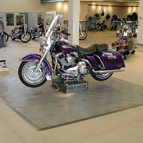 Harley-Davidson retail motorcycle stand display with RaceDeck Diamond Alloy display pad.