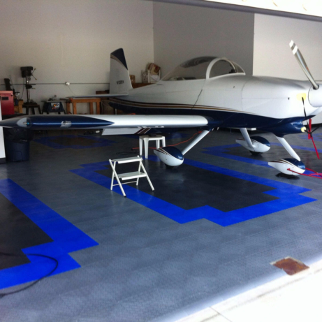 RaceDeck Diamond flooring in a custom pattern with edging for this airplane hangar.
