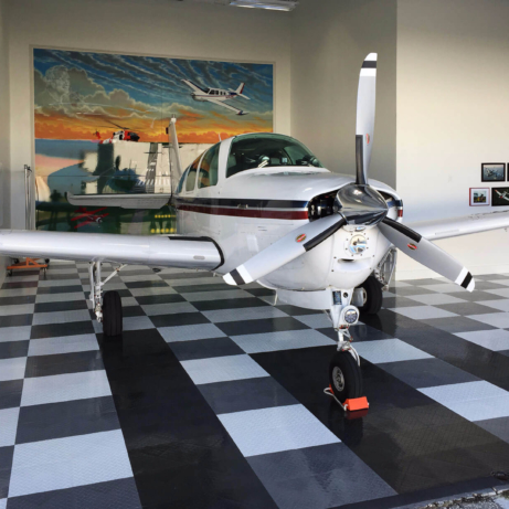 Airplane in a hangar with RaceDeck Diamond flooring.