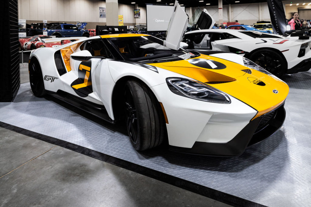 A Ford GT and a Lamborghini on display at the Luxe Automotive booth with alloy diamond garage flooring.