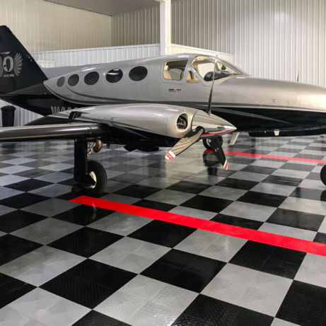 Airplane hangar with a Cessna 414. RAM - Series VI  and a RaceDeck Diamond TuffShield airplane hangar floor.