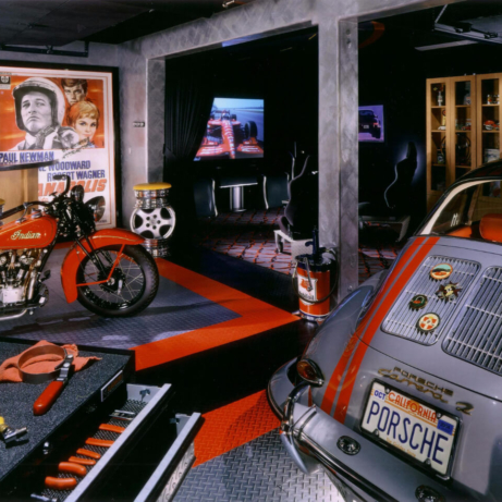 A man cave with a vintage indian motorcycle, a classic Porsche, and RaceDeck Garage Flooring.