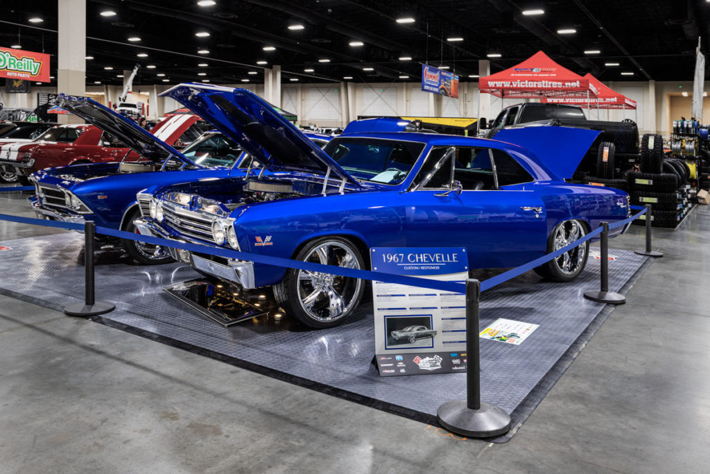 A 1967 Chevrolet Chevelle built buy Mile High Muscle in a car show booth with a RaceDeck Diamond floor.