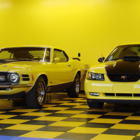 New and classic Mustangs in a brightly colored garage