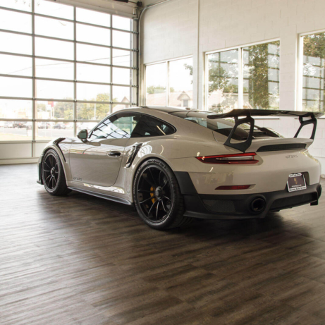 A Porsche GT2 RS parked on Smoked Oak display flooring