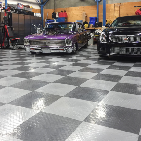 A shop with two Cadillacs and RaceDeck XL garage flooring