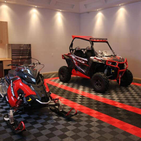 Snowmobile and side-by-side on Free-Flow garage flooring