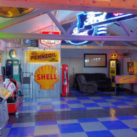 Interior view of the colorful garage; vintage memorabilia, neon signs, RaceDeck TuffShield flooring