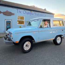 he Olympia Seafood Co. with a blue Bronco parked in the front.