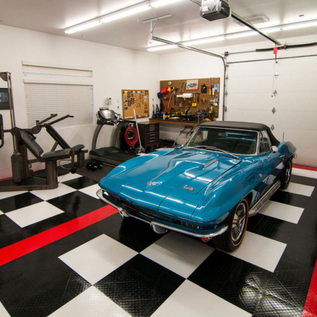 A classic Vette in a garage with exercise equipment and RaceDeck Diamond garage flooring.