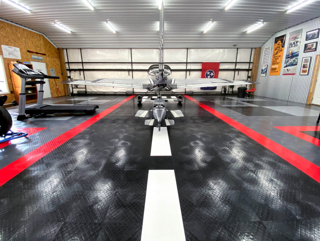 View of Paul's RaceDeck Diamond garage with airplane and exercise machines.