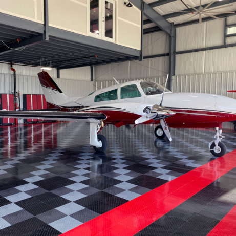 Airplane Hangar with RaceDeck Tuffshield Diamond flooring in red, black, graphite, and alloy