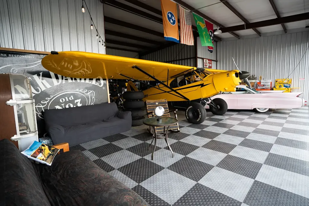 GOTY gallery An airplane and classic car park in a hangar with RaceDeck modular garage flooring tiles