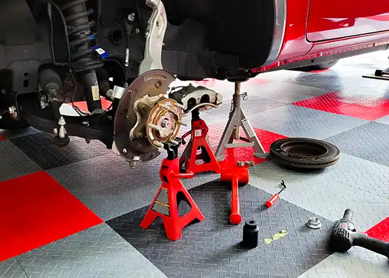 Car on jack stands with tire and brake calipers removed