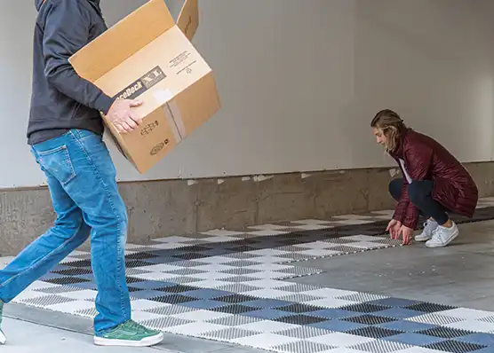 A renter and his daughter remove their RaceDeck floor.