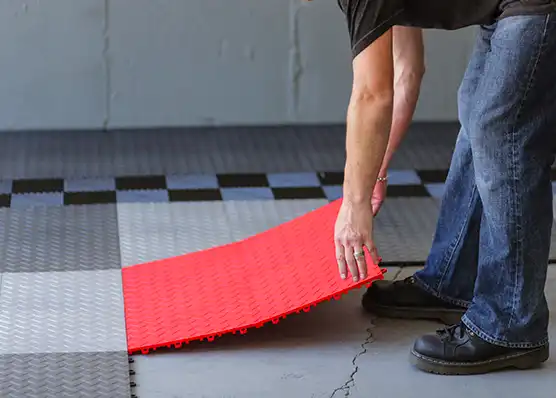 A detailer installs his new RaceDeck floor.