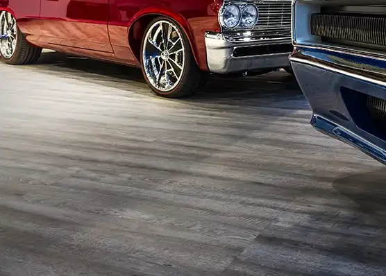Classic cars parked on Smoked Oak in an automotive showroom