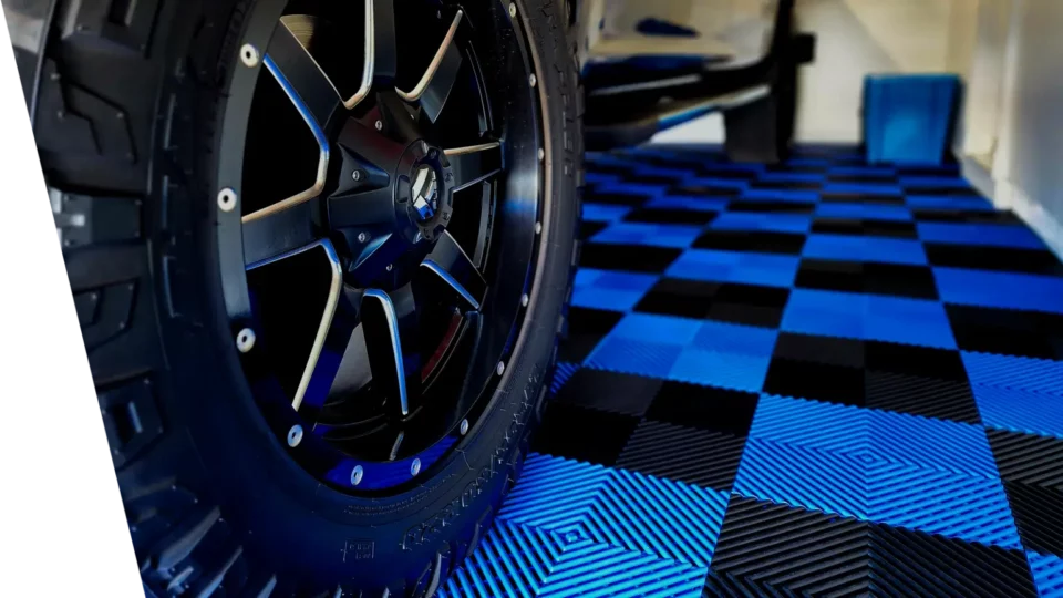Blue and Black Interlocking Garage Floor Tiles under a car