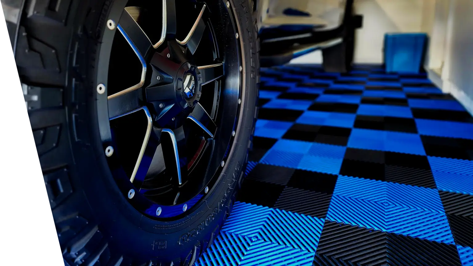 Blue and Black Interlocking Garage Floor Tiles under a car