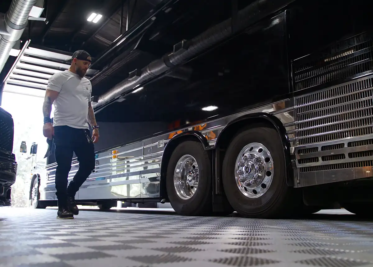 Brantley Gilbert inspects his tour bus parked on RaceDeck flooring.