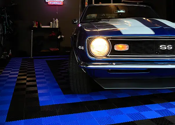 Camaro SS parked in a garage with black and blue Free-Flow garage floor tiles