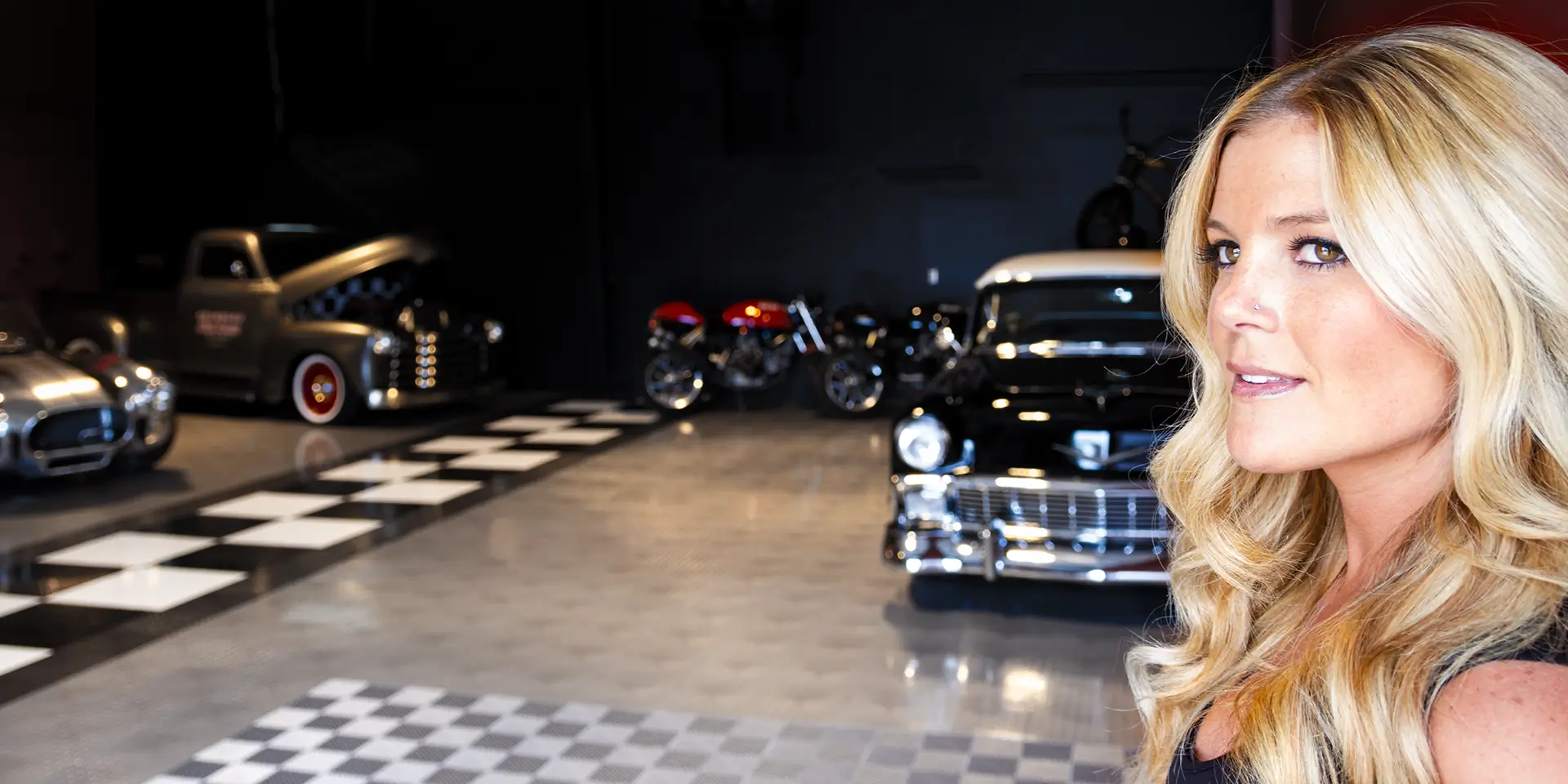 A woman walks through a large garage with RaceDeck tiles.