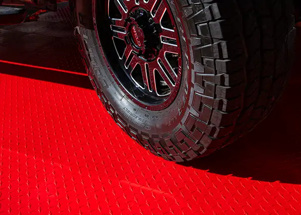 F-150 with off-road tires on RaceDeck Max Flooring