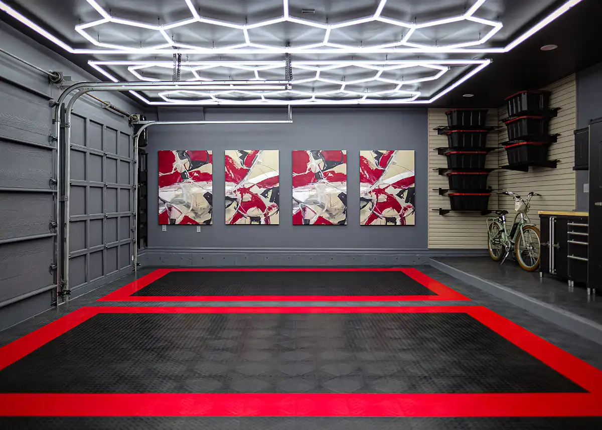 Custom garage floor in a grage with three non objective paintings and a bicycle.
