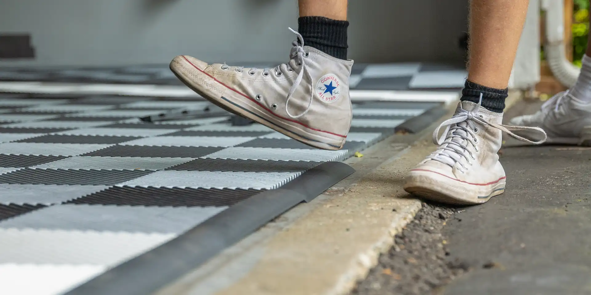 Young man installing edges on a RaceDeck Garage Floor