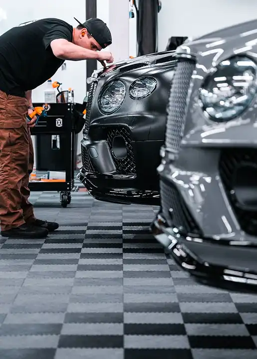A detailer works in a shop with RaceDeck Free-Flow XLC