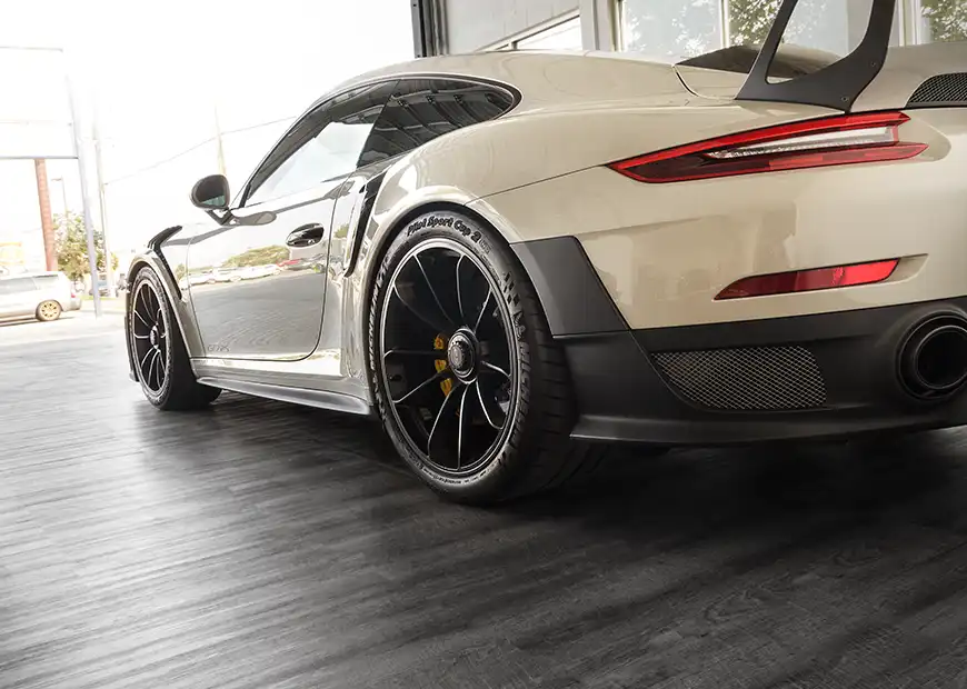 Porsche leaving a showroom with Smoked Oak flooring