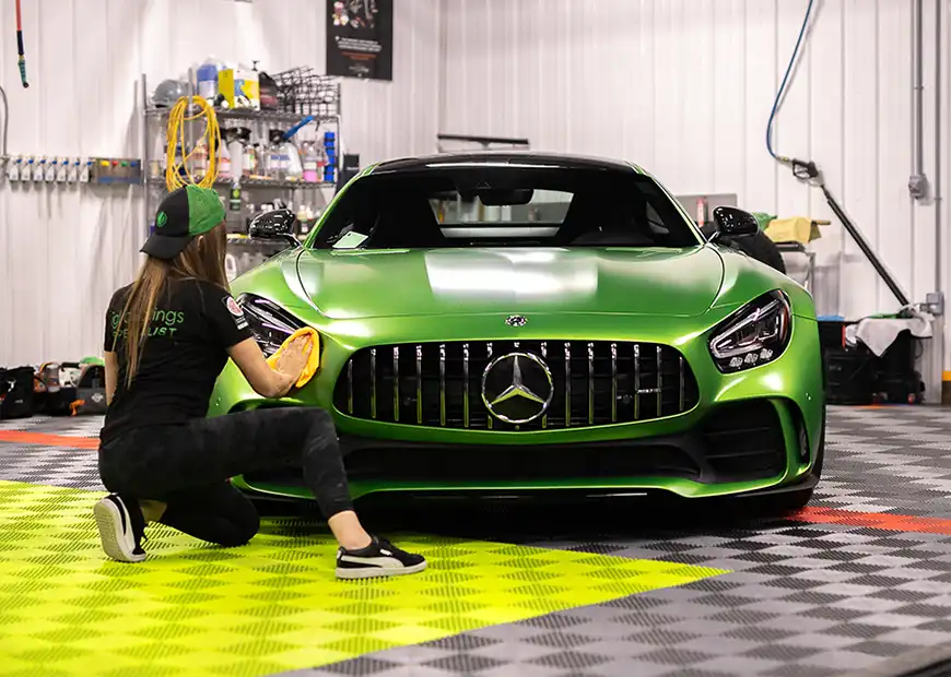 Detailer at Sweet ride detailing details a car on Free-Flow flooring.