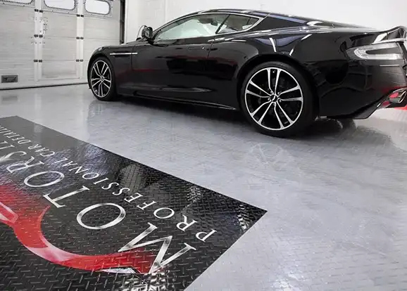 Car in detailers shop with TuffShiled floor and a custom painted graphic