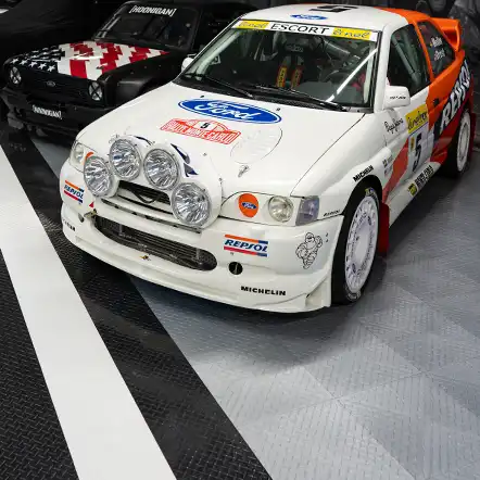 Rally cars in a shop with XL flooring