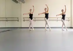 Three ballerinas practice on a Balletdanse Plus Dance Floor from Stagestep