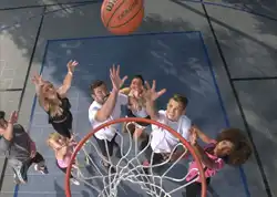 Families play a game of basketball on their Sport Court